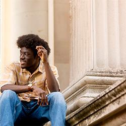 Person-centred photography example - student in front of building.