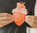 Hands holding an image of a heart