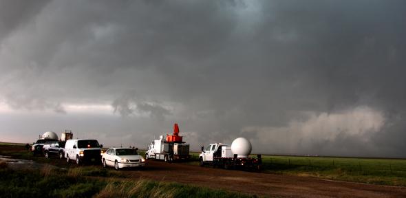 Vehicles with weather observation equipment track a storm